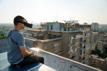 Man with drone flying at the city