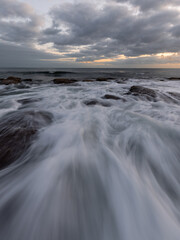 Wave water flowing between rocks.