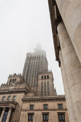 Vintage building Palace of Culture and Science on a foggy day in Warsaw. Socialist Realism Architecture
