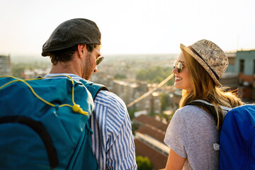 Happy tourists couple, friends sightseeing city with map together. Travel people concept.