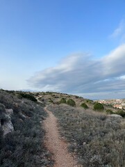 Naklejka premium Hiking walkway in the hills, blue sky, summertime