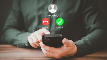 Man answering to incoming call. Phone call from unknown number. Call center gang, scammer or stranger. Hoax person with fake identity. Scam, fraud or phishing with mobile phone or smartphone concept.