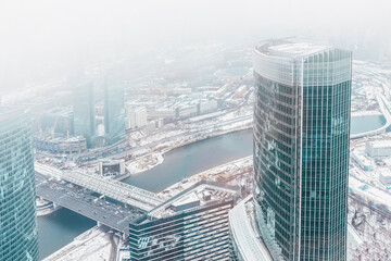 Obraz premium View of modern glass buildings,skyscrapers from the 89th floor on a cloudy winter day. A bird's-eye view of the city landscape