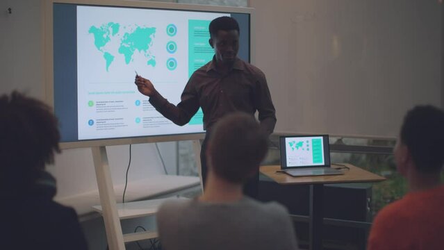 African Assistant Professor Teaching Geopolitics in a Small Classroom Setting