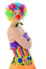Clown in colorful costume posing in studio in front of white background