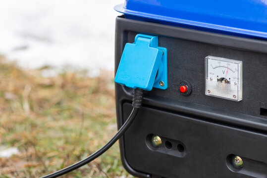 Outdoors Close Up Photo Of Generator Producing Electricity. Winter Season, No Electricity At Home, Blackouts And Machinery Concept