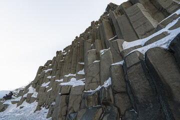 Basaltic or Hálsanef snow columns from below Reynisfjara Black Beach or Vík Black Beach with...