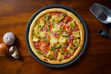 Home made Italian pizza served on the wooden table from top view.