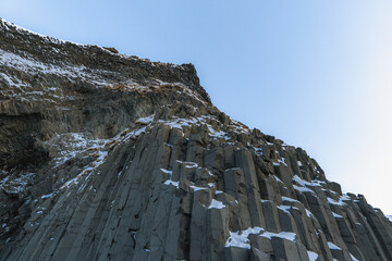 Basaltic or Hálsanef snow columns from below Reynisfjara Black Beach or Vík Black Beach with...