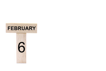 February 6 displayed wooden letter blocks on white background with space for print. Concept for calendar, reminder, date. 