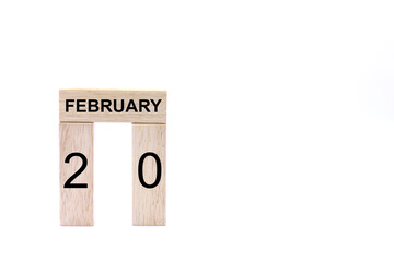 February 20 displayed wooden letter blocks on white background with space for print. Concept for calendar, reminder, date. 