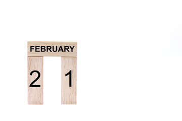 February 21 displayed wooden letter blocks on white background with space for print. Concept for calendar, reminder, date. 