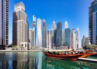 Fototapeta na wymiar Dubai Marina at day with boat and blue sky, UAE
