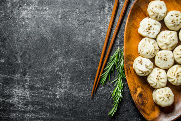 Obraz na płótnie Canvas Dumplings manta on a plate with rosemary.