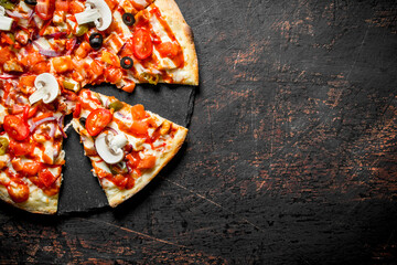 Slices of crispy pizza with tomatoes, peppers and mushrooms.