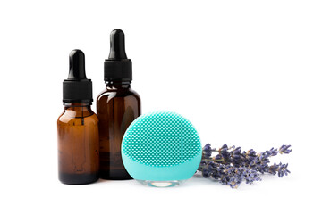 Facial cleansing brush, massage serum or essential oil, cream isolated on white background. Cosmetic accessory. Beauty concept.