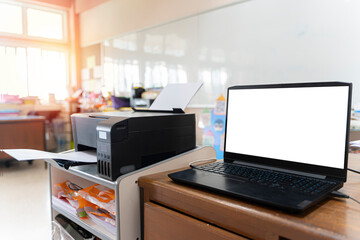 Printer and computer. interior of a school classroom, wooden floor and desks. concept of education and learning.