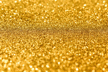 Golden yellow shiny light bokeh background.  New Year, Christmas and all celebration background concept. 