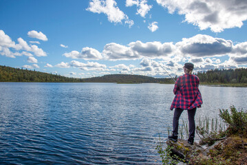 Fototapeta na wymiar Woman fishing on the lake