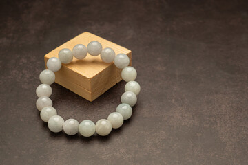 White jade bangles on a wooden cubes over a table © meeboonstudio