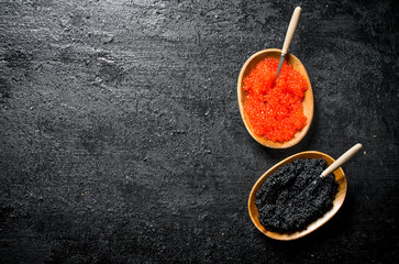Fototapeta premium Black and red caviar in bowls with spoons.
