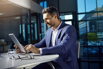Fototapeta premium Technology, modern office and businessman with tablet reading crypto data online. Financial trading, cryptocurrency and investment, man thinking at table with internet research or analytics.