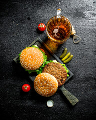 Burgers and beer in a glass.