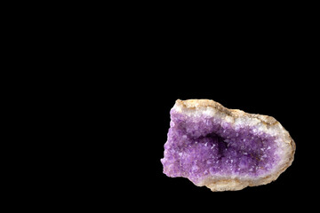 Druse amethyst on a black background with copy space. Jewelry, gemology, geology.