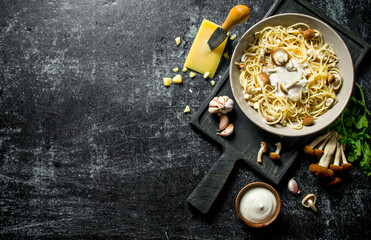 Pasta in bowl with mushrooms, herbs and cheese.