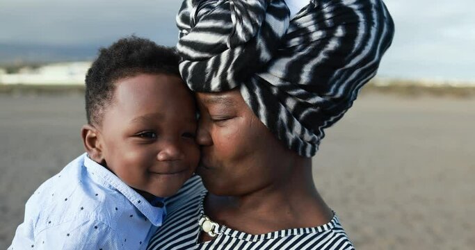 African mother having tender moment with little son outdoor - Family moments and love concept