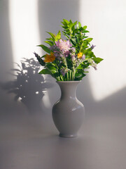 Beautiful cottage style flower arrangement, in a white vase