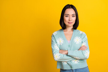 Photo of successful serious lady wear stylish print outfit stand near empty space ad banner isolated on yellow color background