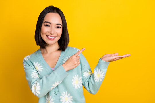 Photo of gorgeous lovely lady wear stylish print clothes arm demonstrate empty space nice offer isolated on yellow color background
