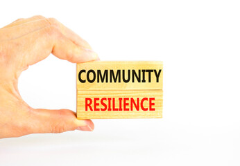 Community resilience symbol. Concept word Community resilience typed on wooden blocks. Beautiful white table white background. Businessman hand. Business and community resilience concept. Copy space.