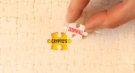 Crypto downfall symbol. Concept words Cryptos downfall on white paper puzzles. Beautiful yellow table white background. Businessman hand. Business and crypto downfall concept. Copy space.