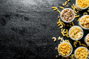 Assortment of dry pasta in bowls.