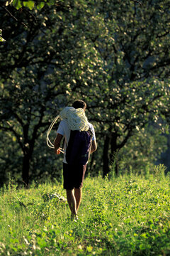 Man on his approach hike with a rope.