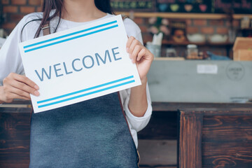 Welcome. Young startup owner small cafe shop.