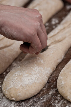 baker preparing baguettes at bakery