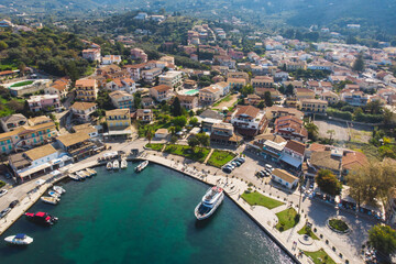 Obraz na płótnie Canvas Aerial drone view of Kassiopi, village in northeast coast of Corfu island, Ionian Islands, Kerkyra, Greece in a summer sunny day, with marina, town, beach and castle