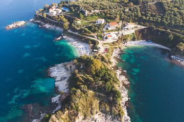 Obraz premium Aerial drone view of Kassiopi, village in northeast coast of Corfu island, Ionian Islands, Kerkyra, Greece in a summer sunny day, with marina, town, beach and castle