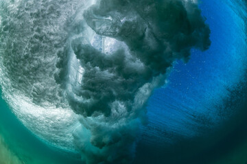 underwater wave crashing with sun rays and undersea clouds