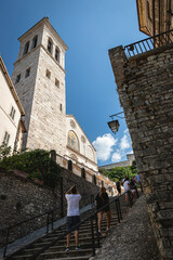 Glimpse from a side street overlooking the Cathedral of Spoleto in Umbria (Italy) - 562381959