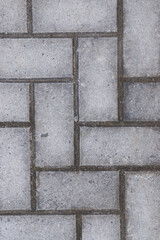 Concrete sidewalk forming a beautiful texture or background. Selective focus.