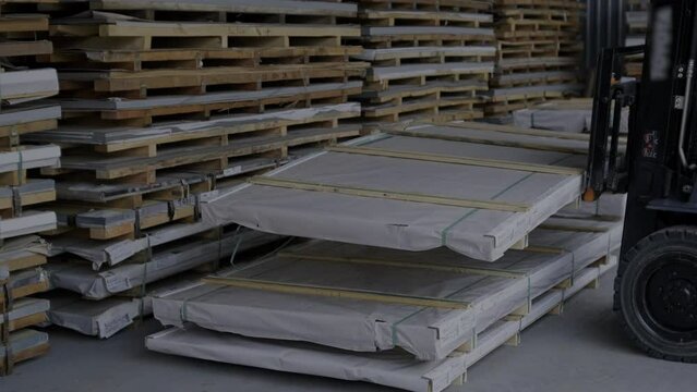 Forklift in a large industrial warehouse of stainless steel. Warehouse for stainless steel