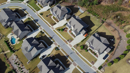 Row of two story houses with swimming pool, large backyard and well trimmed front yard in upscale residential neighborhood outside Atlanta, Georgia, US