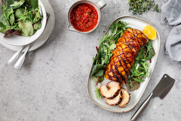 Porchetta, a delicious pork roast wrapped in a roll. Traditional Italian dish for holidays on a...