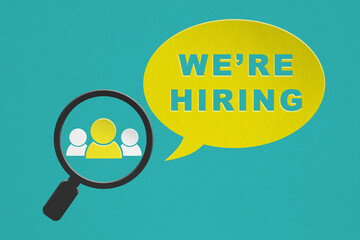 For job vacancy , human resource concept. We are hiring word on yellow paper cut and yellow person icon inside magnifying glass on grunge green background