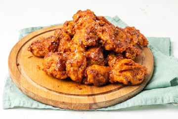 Spicy pieces of chicken on a wooden board,Asian style