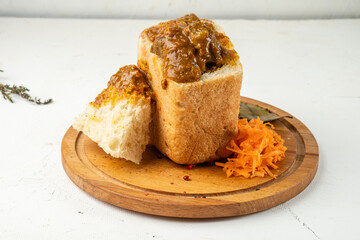 Traditional African beef and vegetable curry served in white bread. Close-up. Traditional cuisine.
